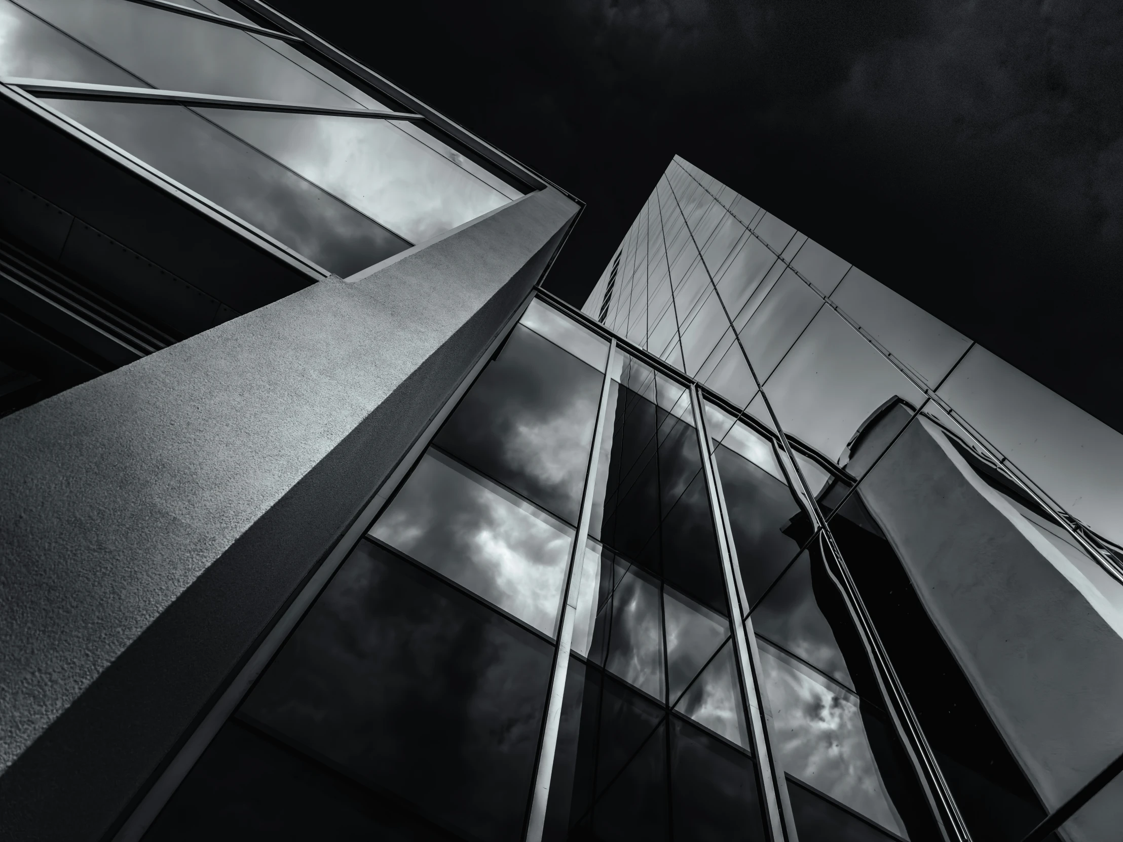 two glass buildings with sky background