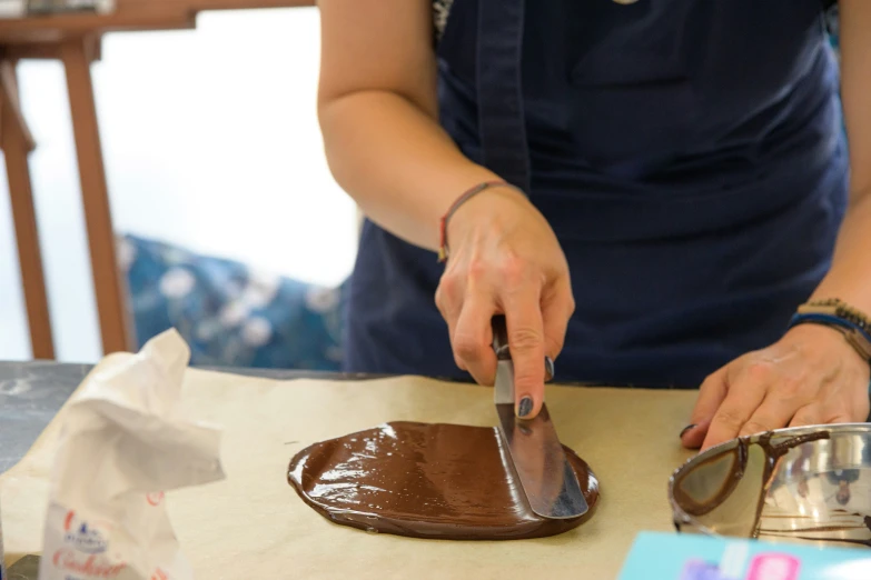 a person is plating chocolate onto a platter