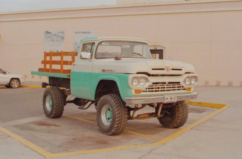 an old truck with the flat bed on it's wheels