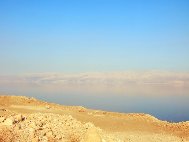 the sky is clear and blue above some water