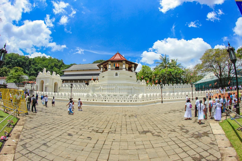 people walk around an ornate park like setting