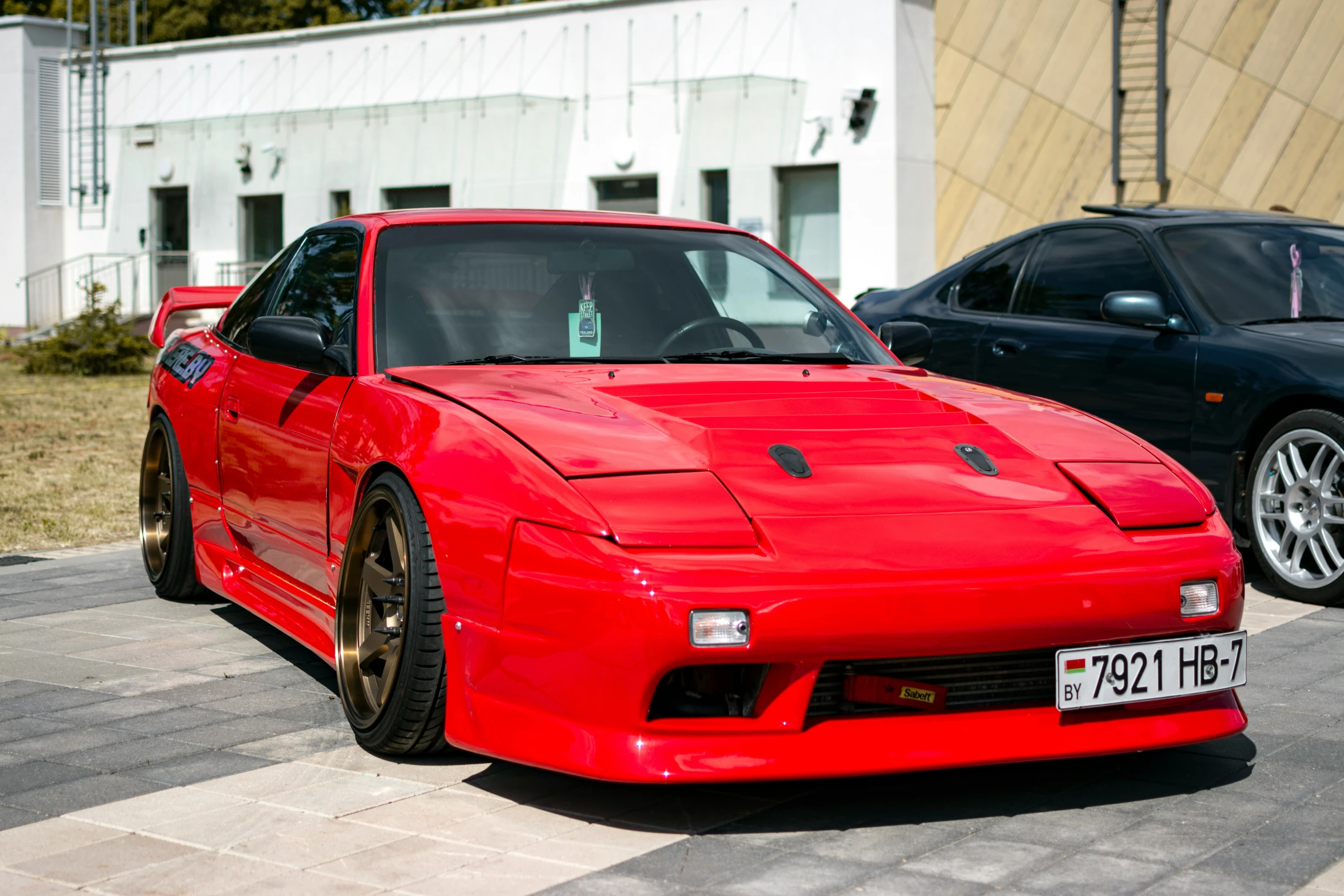 an attractive and exotic red sports car in the street