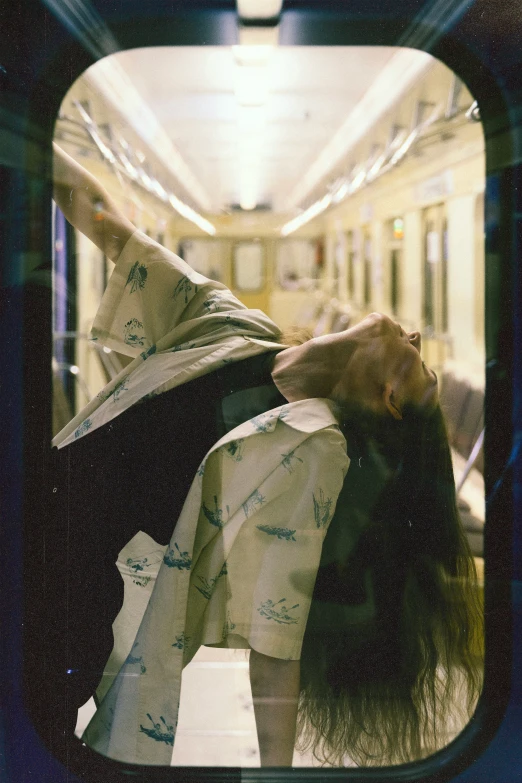 a po looking through the train window at a girl with long hair