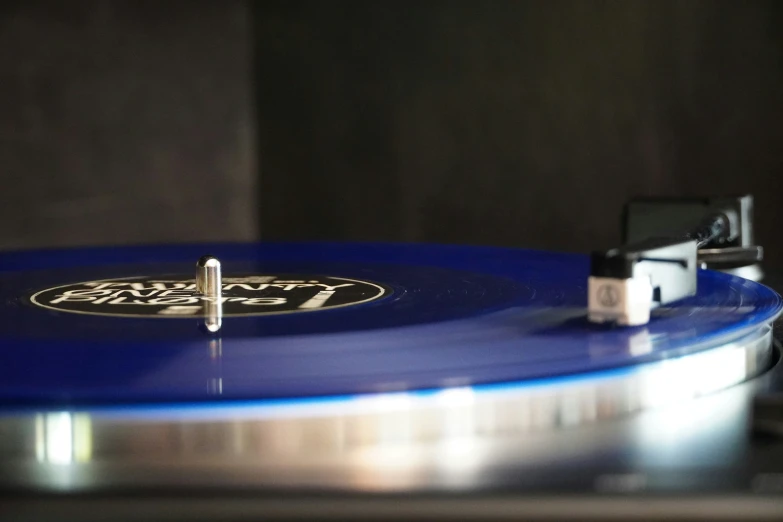 there is a blue record player on the table