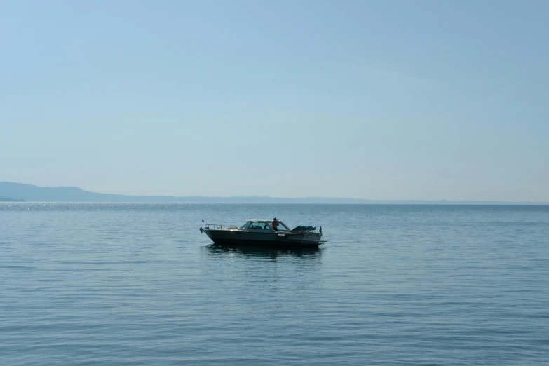 two men in a boat on a very calm sea