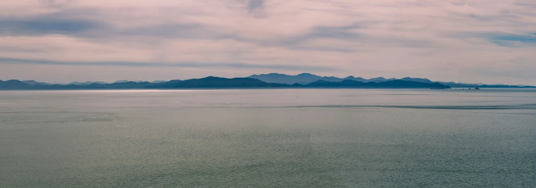 a group of large mountains in the middle of the ocean