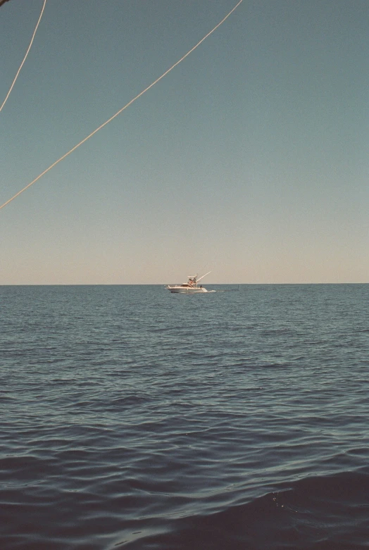 two boats floating in the middle of an ocean