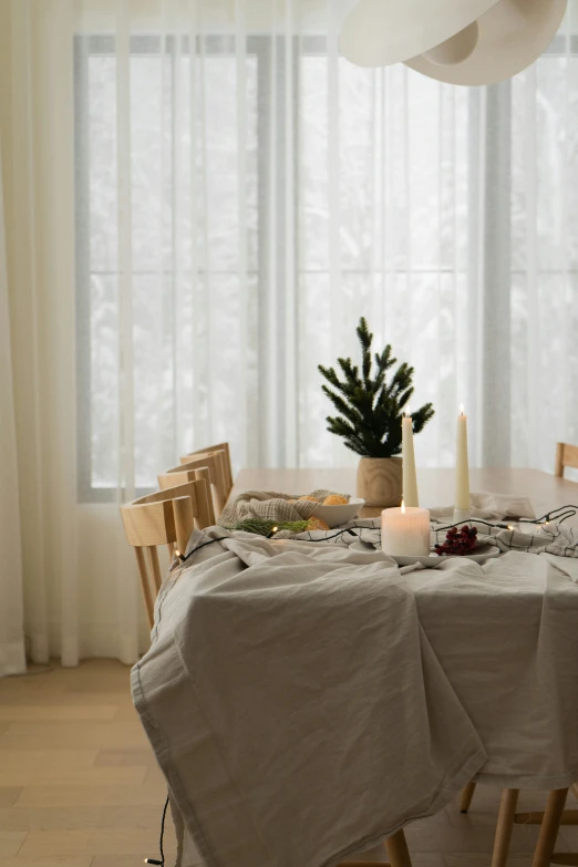 a round dining table covered in a blanket