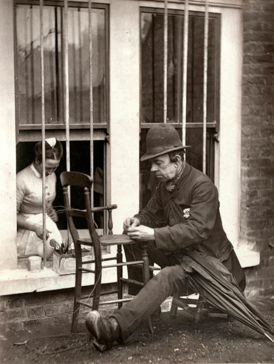 an old man sitting on a rocking chair looking at a piece of paper