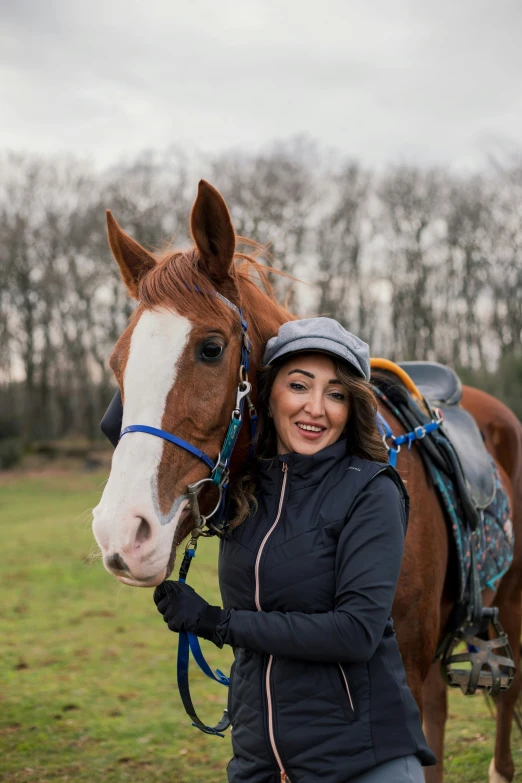 the woman is walking next to her horse