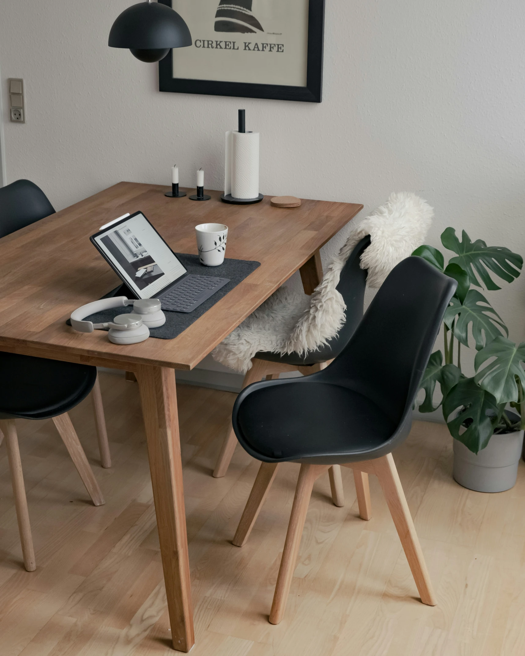 a wooden table that has some chairs next to it