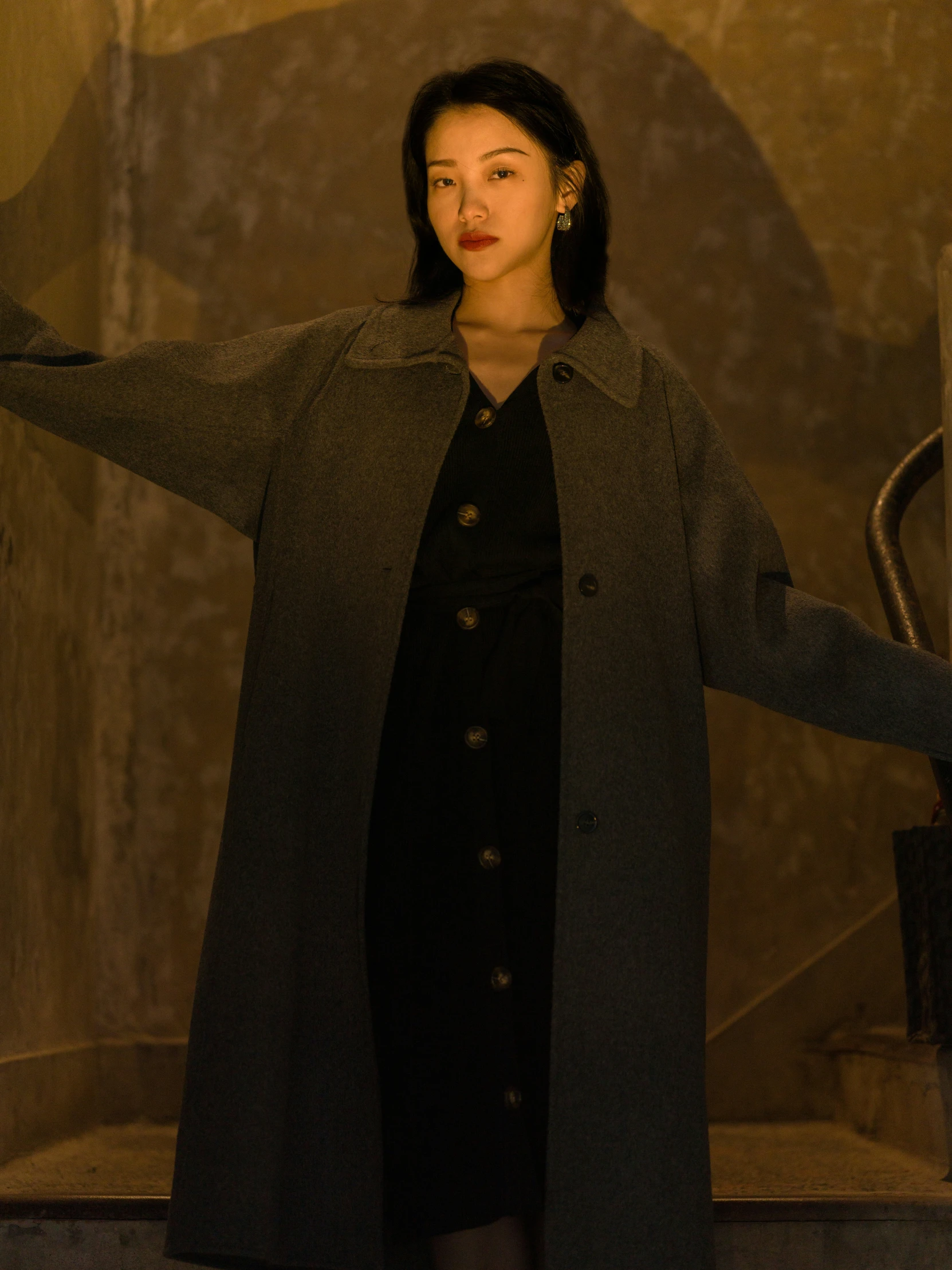 a beautiful young woman wearing a long coat