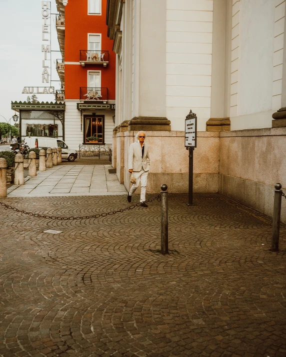 an empty street with red buildings and signs