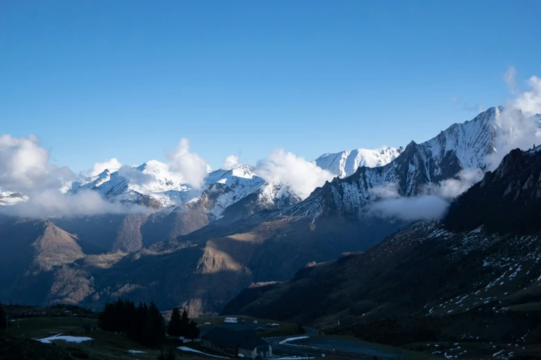 mountains and clouds in the distance are covered by snow