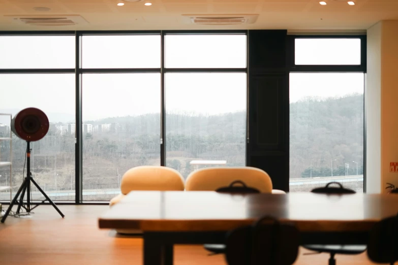 chairs and a table with chairs in front of large windows