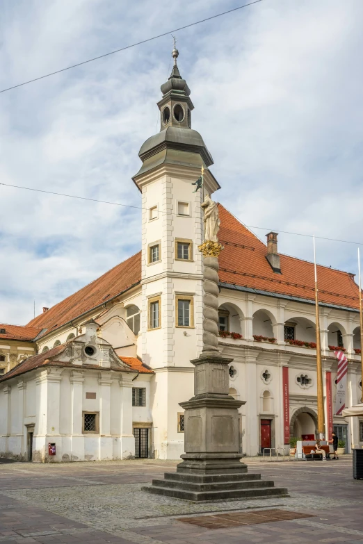 a building with a clock tower and flags on it