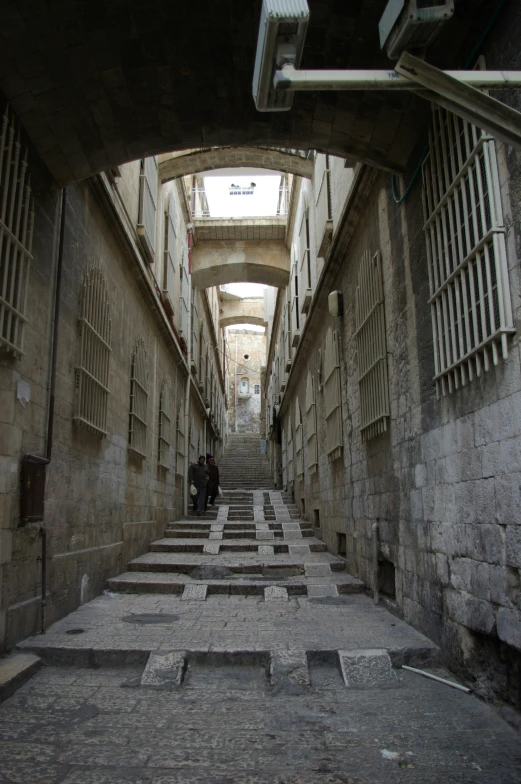 a narrow alley with a staircase and a skylight