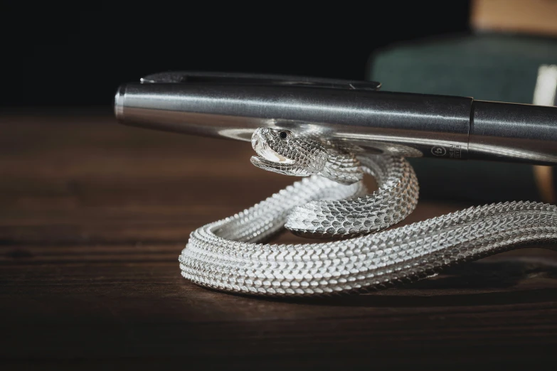 a rope of ided cotton is laying on a table next to a cellphone