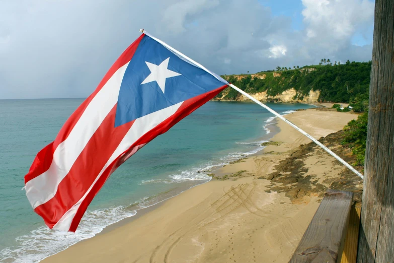 an american flag on the side of a beach