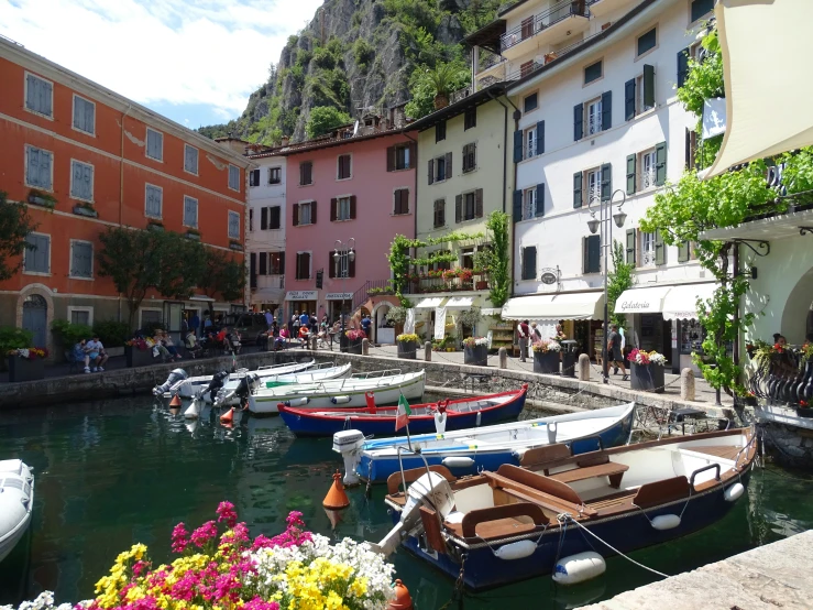 several boats docked next to buildings and a river