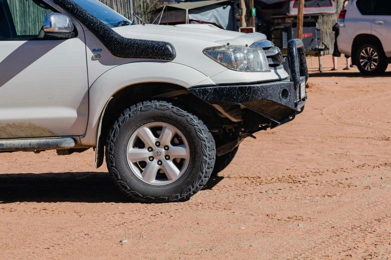 the white toyota frontier has just hit the mud