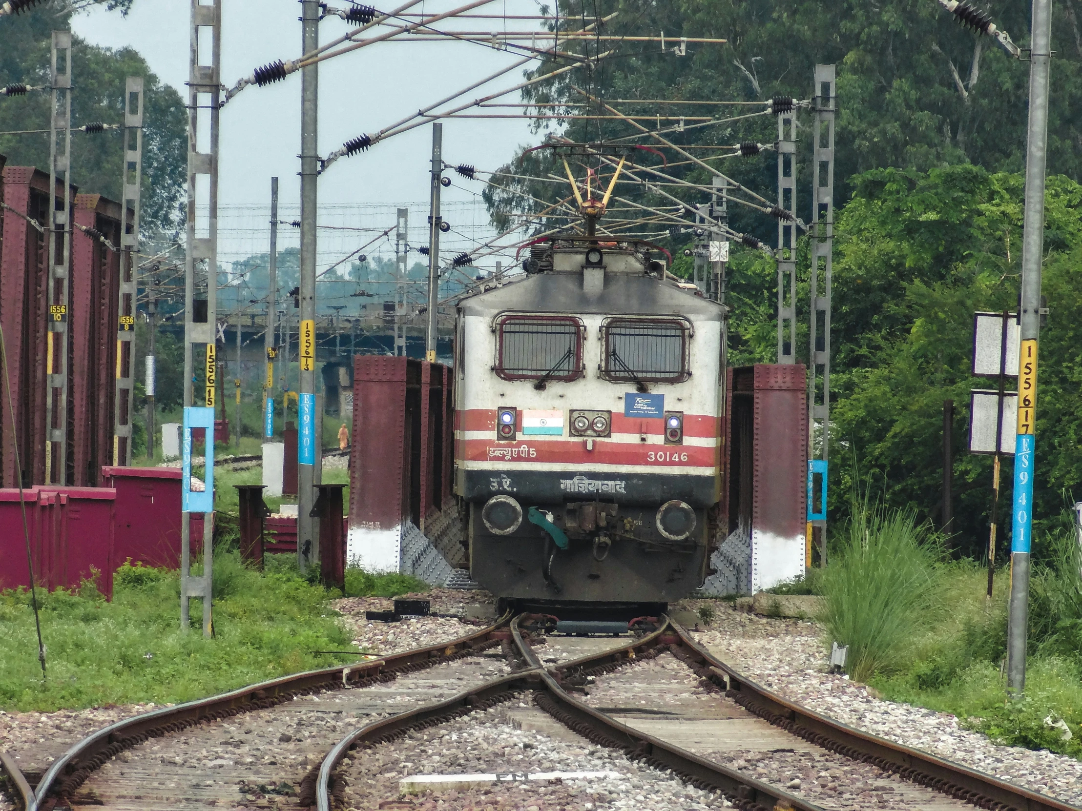 the train is on tracks through the countryside