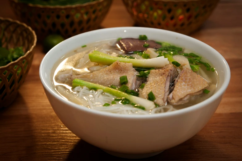 a white bowl filled with meat and vegetables