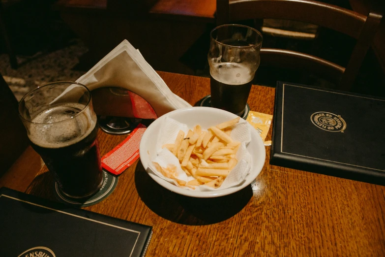 food and two beer are sitting on the table