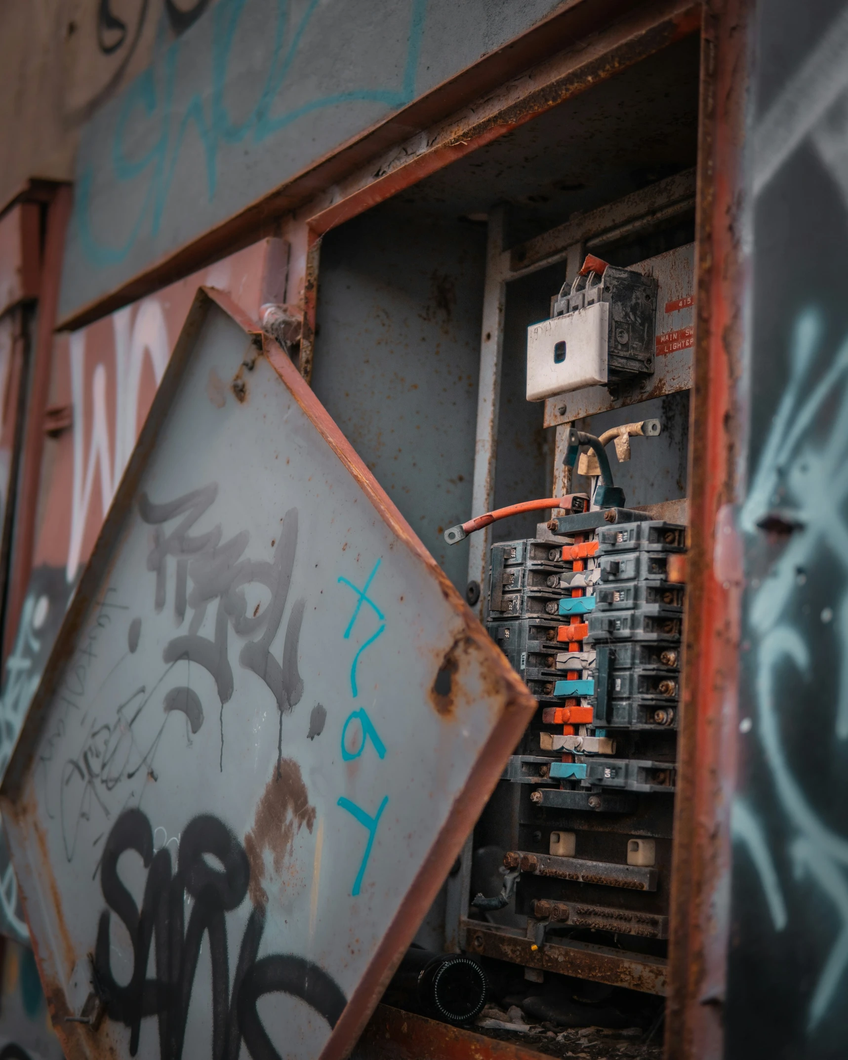 an open, rusty box with lots of graffiti on it