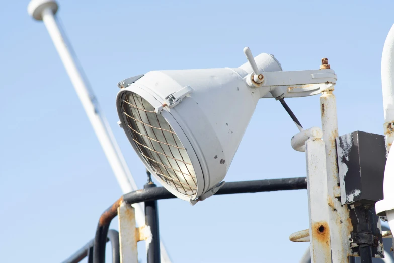 an old white lamp on top of a metal pole