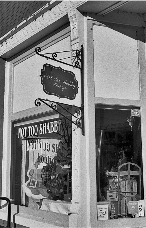 the front of an empty storefront with a sign