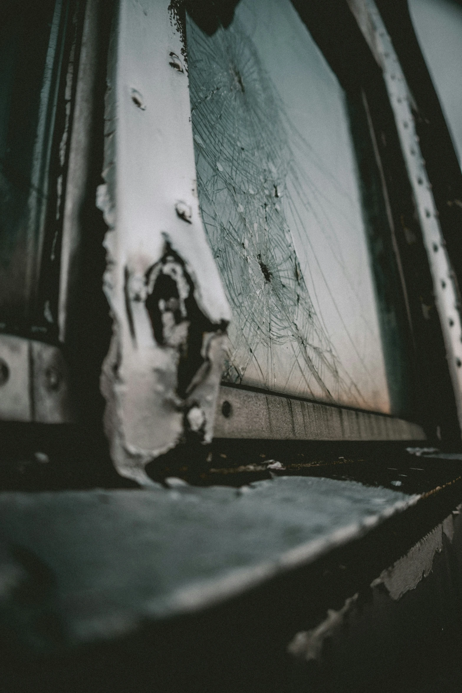 the view from inside of an open vehicle with dirt on the floor and a window