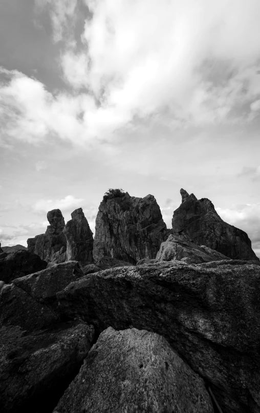 rocks on an island on the beach under cloudy skies