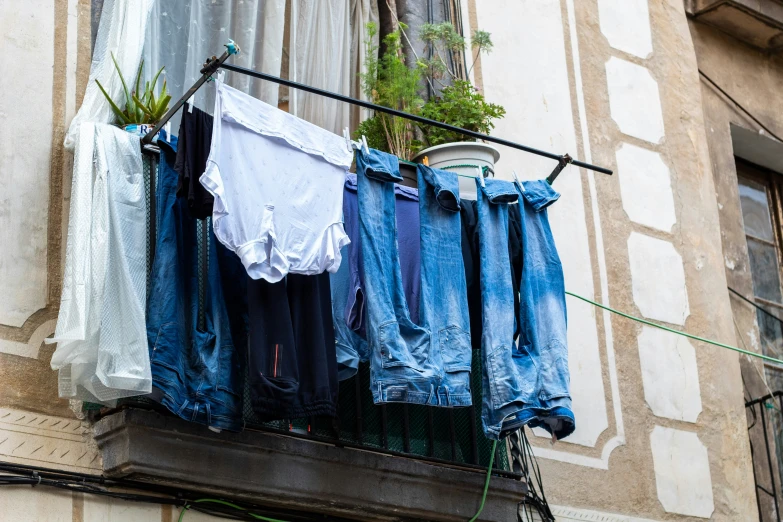 a set of clothes is hanging outside in the rain