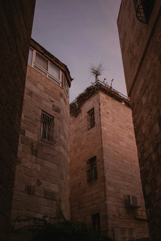 two tall buildings with a tower and some people on top of one