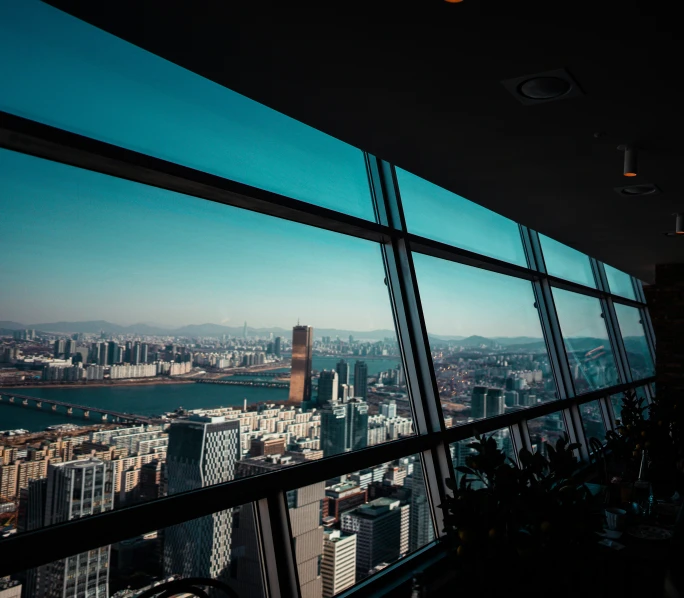 view out of window in high rise building looking into city below