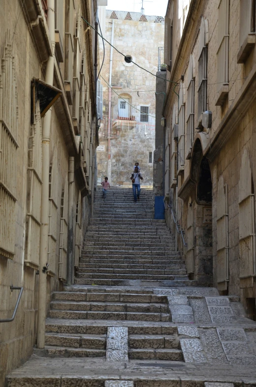 a man sitting on the back step of an old stone staircase