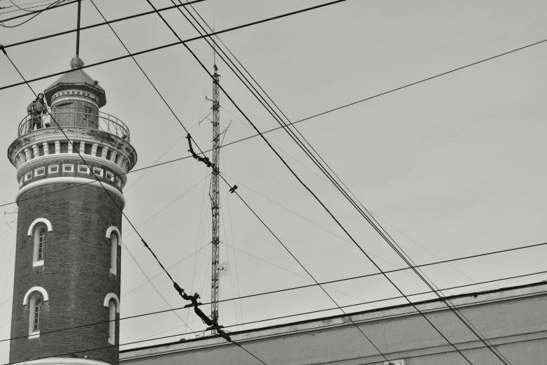 the clock tower is next to a metal wall