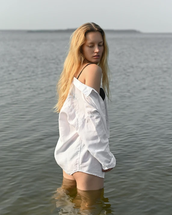 a woman in shorts is standing in some water