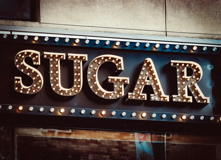 the word sugar with illuminated letters below it