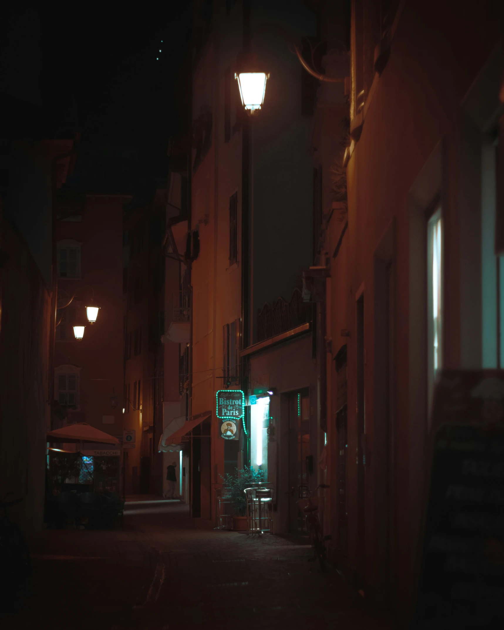 a city street at night with lights on