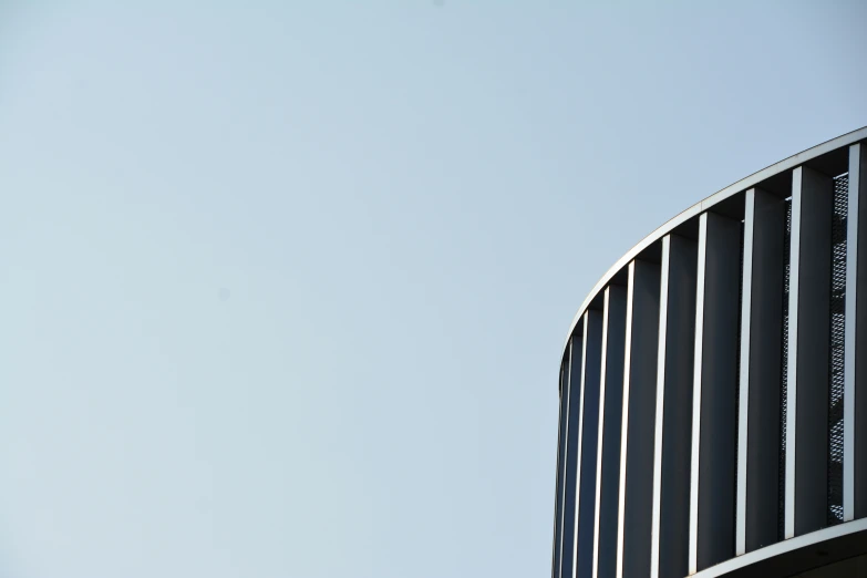 the corner of a building with an airplane flying over it