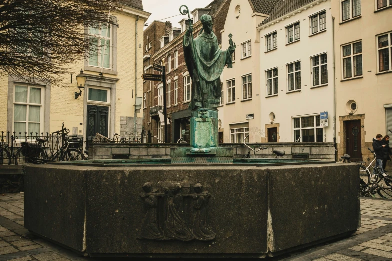 a statue on top of a table next to a building