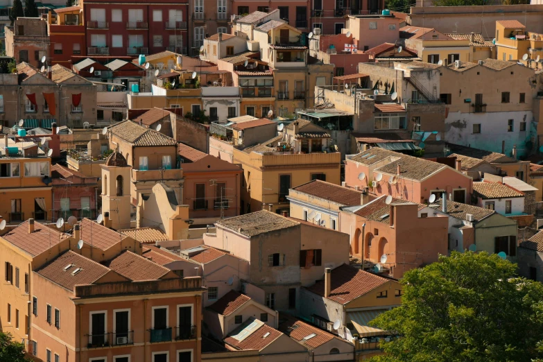 many large buildings with tan roofs with trees