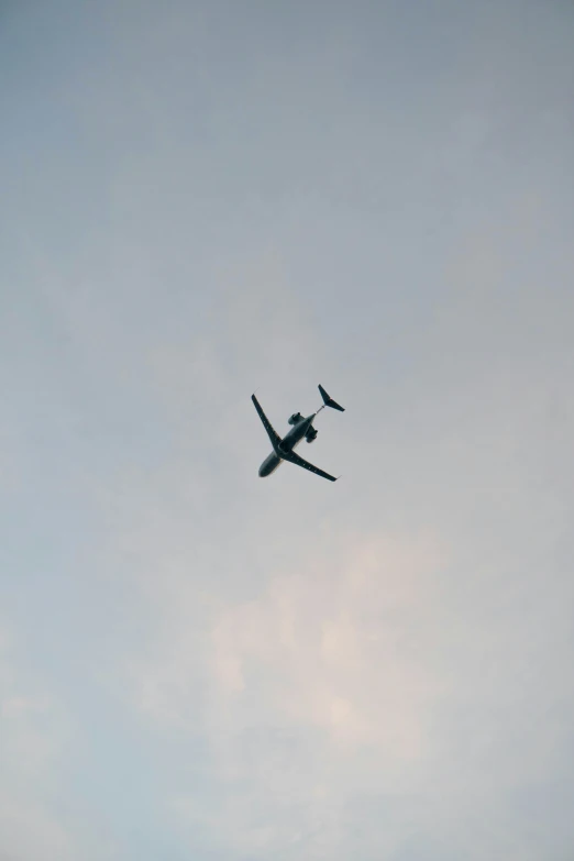 an old airplane flying high up in the sky