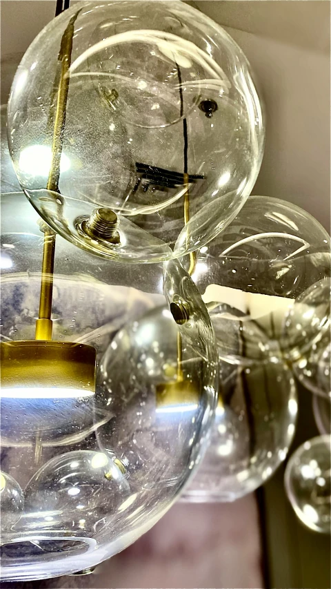 a number of blown glass balls hanging from a ceiling