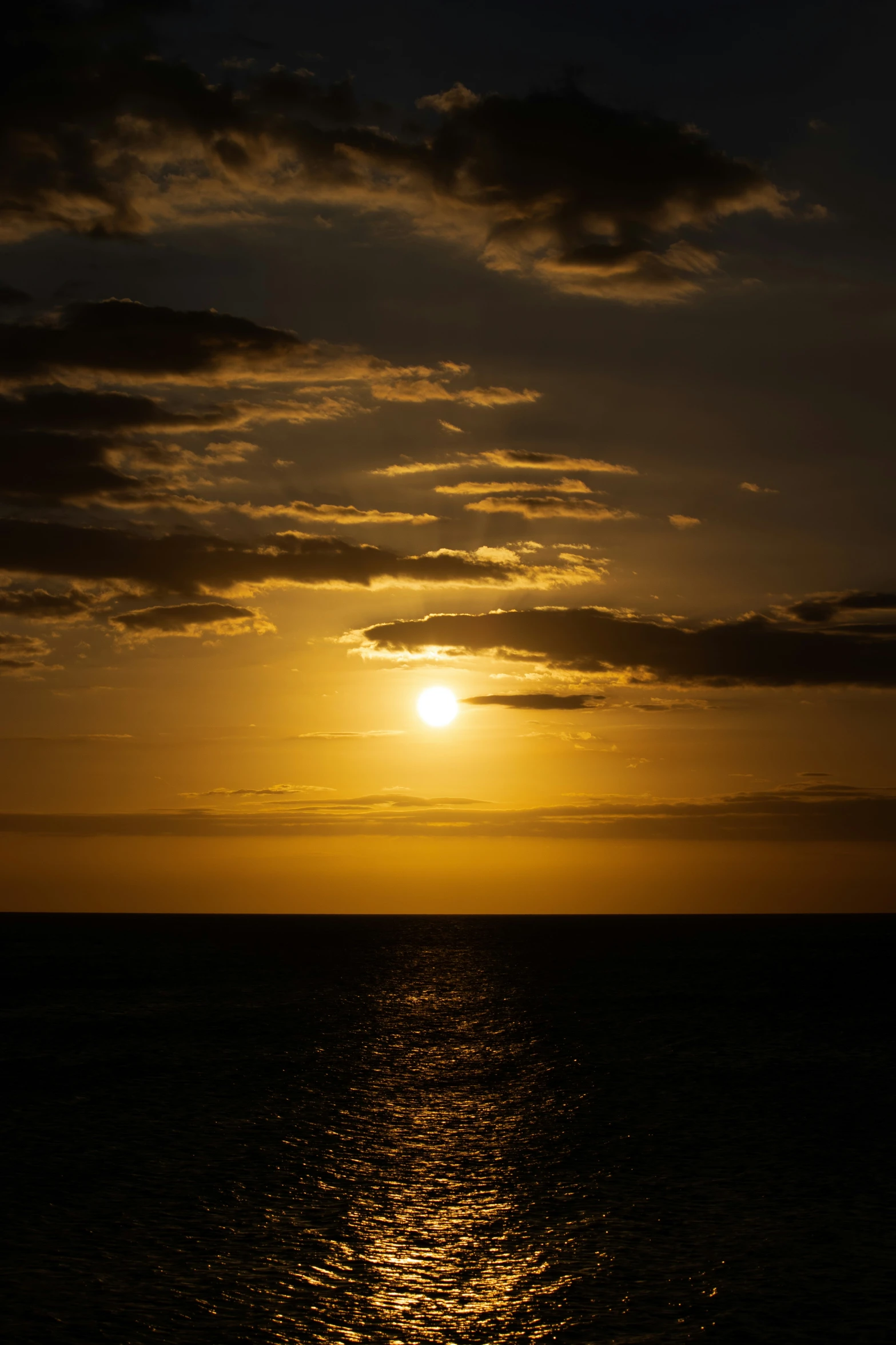 the sun setting over a body of water