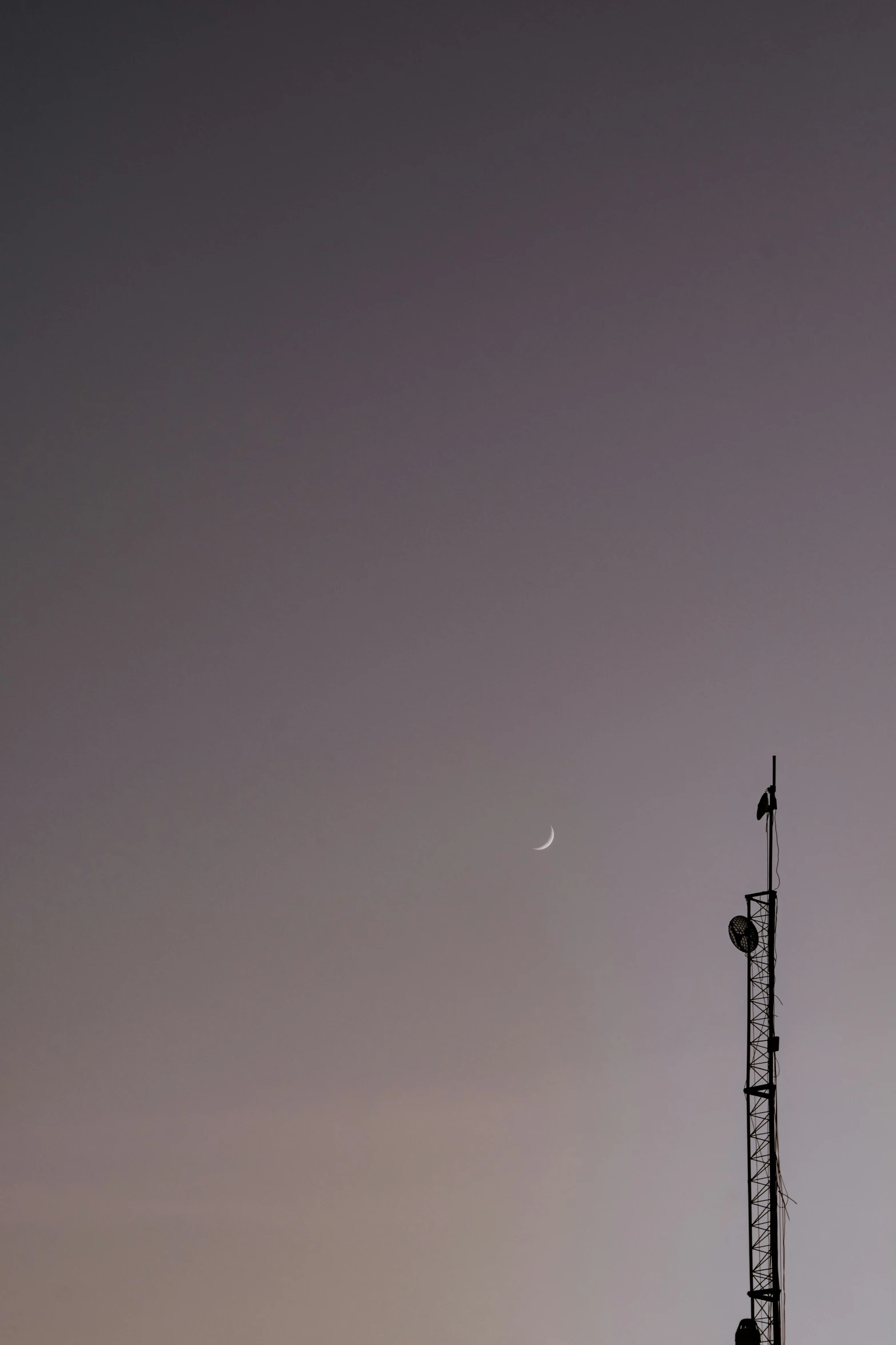 an antenna pole and several traffic signals