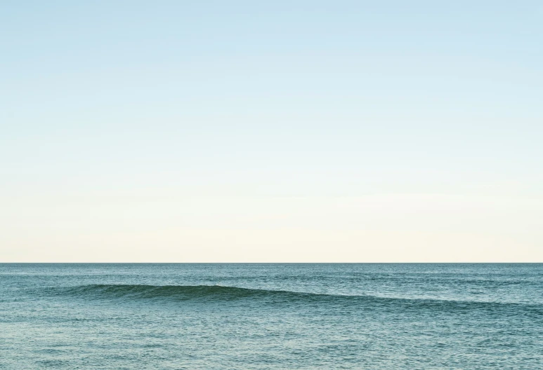 a sail boat that is out in the ocean