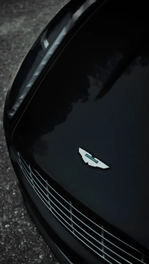 the front of a black sports car parked on the street